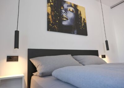 Modern eingerichtetes Schlafzimmer mit Kunst an der Wand